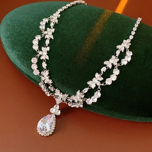 Macro shot of silver-tone teardrop pendant necklace with sparkling cubic zirconia stones