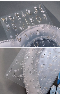 Detail of TL-298 embossed nail stickers with gold and silver snowflake and star patterns