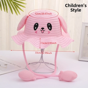 Detailed view of kids straw sun hat with pink moving rabbit ears and cute face embroidery