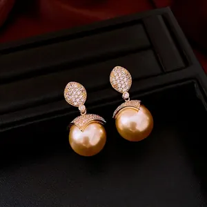 Elegant 18k gold plated drop earrings with large golden pearls and pavé zircon stones