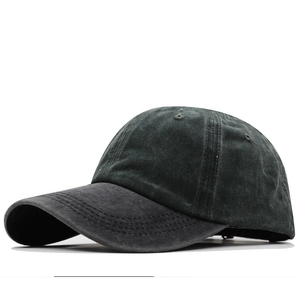 Detail of vintage washed charcoal grey cotton baseball cap with curved brim and stitching