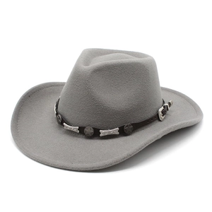 Detail of grey wool felt cowboy hat featuring star studs and brown leather hatband
