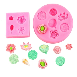 Pink silicone molds for crafting lotus flowers, leaves and fish shapes on white background