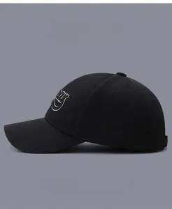 Detail of embroidered smile pattern on a black high-density cotton baseball cap