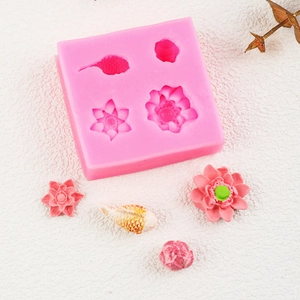 Macro detail of pink silicone mold with 3D lotus and koi fish shapes for fondant