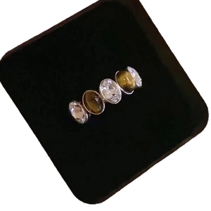 Minimalist silver zircon tiger eye open ring shown in a black velvet jewelry box