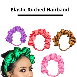 Close-up detail showing the satin texture and elastic pleated design of wide headbands