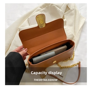 Interior view showing the large capacity of the brown chain bag with phone and wallet
