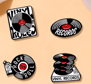 Set of four music-themed vinyl record enamel pins in classic black red and white colors