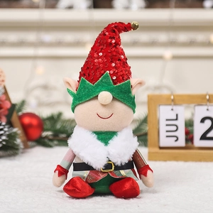 Christmas faceless gnome doll with red sequin hat and green mask on a festive table