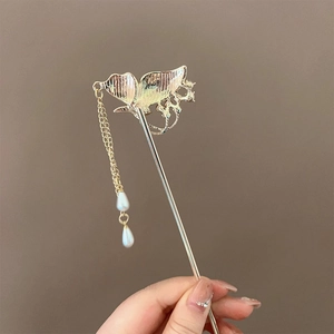 Detail of golden butterfly hair stick featuring elegant tassels and imitation pearls