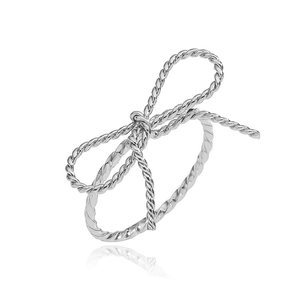 Macro view of silver bow-knot ring with elegant spiral texture on a white background
