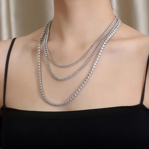Close-up of triple-layered silver titanium necklace with sparkling rhinestones on model
