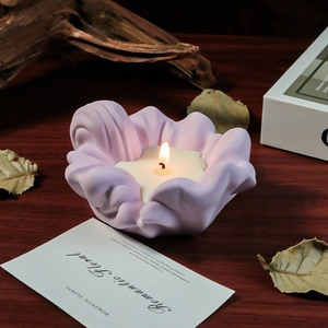 Macro view of wave-shaped candle holder with lavender texture on wooden table