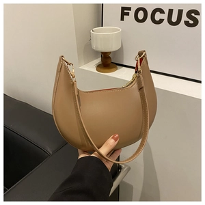 Detail of khaki crescent shoulder bag featuring smooth faux leather and gold hardware