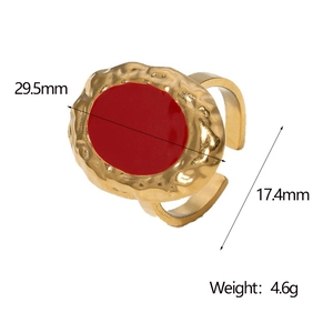 Detail view of gold vintage ring featuring hammered texture and red enamel centerpiece