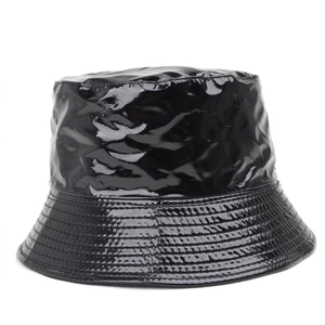 Detail of black glossy patent leather bucket hat showing textured finish and stitching