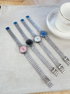 Selection of small dial quartz watches with metal straps in pink, black, white, and blue
