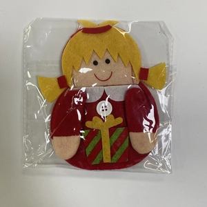 Close-up of handmade felt Christmas girl doll with gift box for cutlery set decoration