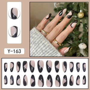 Sparkly black and white almond press-on nails with glitter wave design and holiday theme