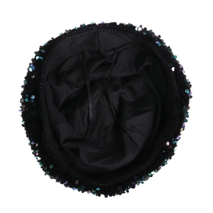 Detail view of black velvet beret featuring colorful sequins and adjustable inner lining