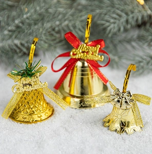 Detailed view of golden Christmas bells with red bows and Merry Christmas lettering