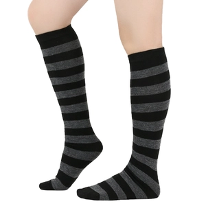 Close-up of black and grey striped knit knee-high socks showing texture and elastic cuff