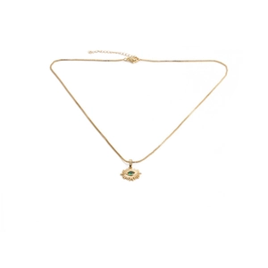 Close-up of golden sun-shaped evil eye pendant with green stone and adjustable chain