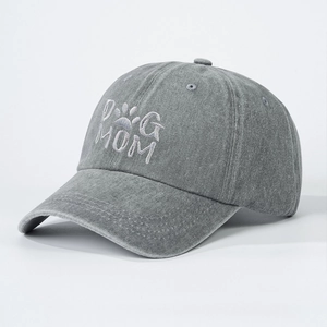 Detailed view of white DOG MOM embroidery on washed dark grey cotton baseball cap
