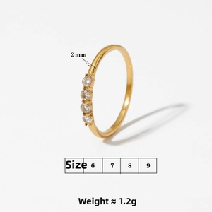 Detail showing 2mm gold stainless steel ring with four small zircon stones and 1.2g weight