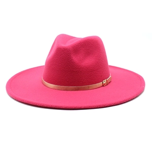 Detail of rose red wool fedora hat featuring a stylish wide brim and gold metal buckle belt