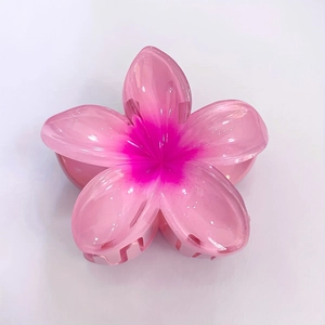 Detailed view of translucent pink plumeria flower hair claw clip with gradient petals