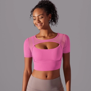 Detail of pink mesh-stitch sports top featuring an oval cutout and breathable fabric