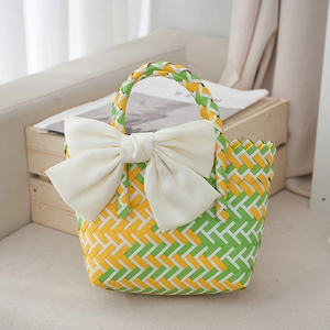 Macro detail of hand-woven basket with large white silk bow on a wooden shelf
