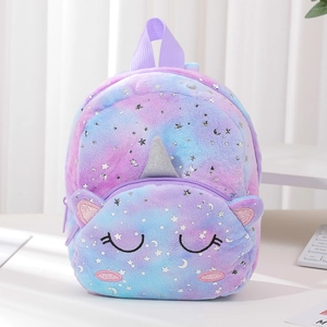 Macro detail of soft tie-dye plush unicorn bag with shimmering silver stars and moon