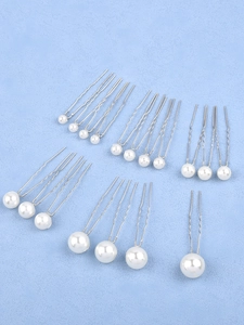 Detail view of pearl hair pins in various sizes with silver U-shaped metal clips