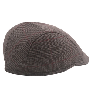 Side view detail of a classic British style plaid beret with dark grey and brown patterns