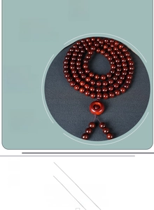 Detailed close-up of sandalwood prayer beads featuring natural wood grain and tassel
