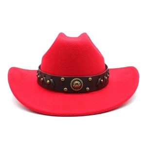Detail of red wool felt cowboy hat featuring brown leather band with metal rivets