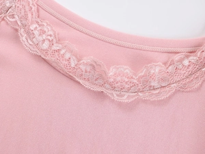 Close-up of pink modal fabric featuring delicate lace trim on the V-neckline