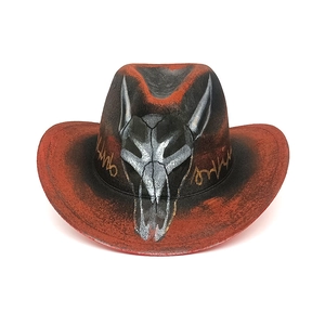 Detail of red and black gradient cowboy hat with hand-painted silver bull skull pattern