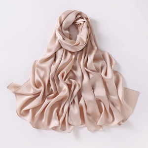 Detailed view of champagne chiffon shawl showing soft silk texture and delicate hem stitching