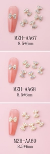 Detailed close-up of alloy bowknot nail art charms with rhinestones and pearls 8.5x6mm