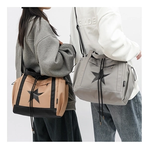 Detail of couple cross-body bags with large star logo and durable nylon texture