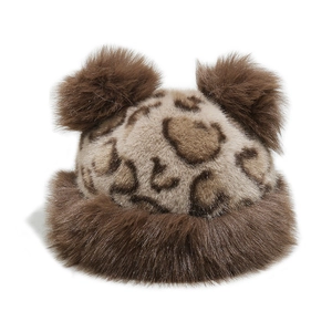 Close-up of leopard print faux fur winter hat with cute plush bear ears and brown trim