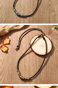 Detailed view of handmade leather football pendants on natural rustic wood background