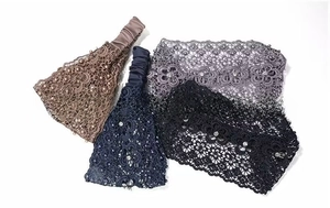 Close-up of lace floral texture with faux pearls and crystals on four elastic headbands