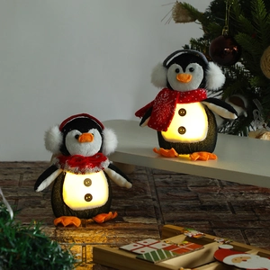 Light-up penguin Christmas ornaments with warm glowing bellies and festive scarves