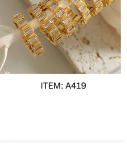 Macro shot of gold plated earrings featuring row-set rectangular cubic zirconia stones