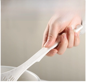 Close-up of long white heat-resistant handle with hanging hole for easy kitchen storage